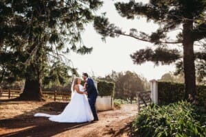 Gledswood Wedding - bride and groom hold hands in the driveway