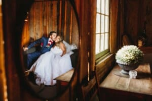 Gledswood Wedding - bride and groom reflected in the bridal suite mirror