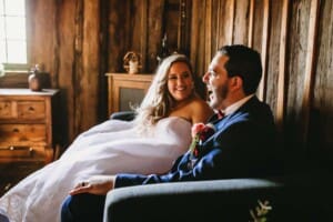 Gledswood Wedding - bride and groom sit laughing in the bridal room