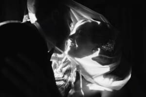 Gledswood Wedding - bride and groom kiss underneath the veil