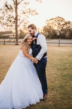 Gledswood Wedding - bride and groom kiss at sunset