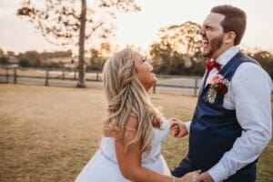 Gledswood Wedding - bride and groom laugh together at sunset
