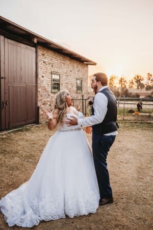 Gledswood Wedding - bride and groom play games as sun sets behind them