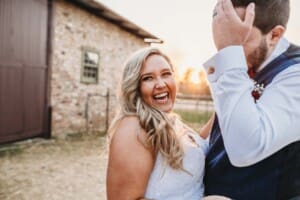 Gledswood Wedding - bride and groom laugh as sun sets behind them