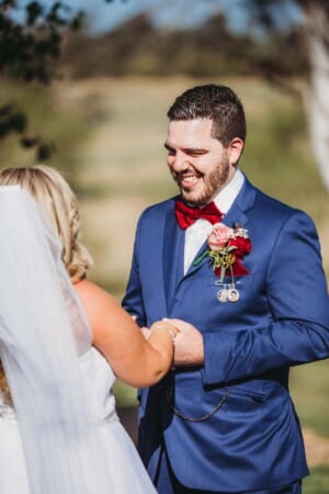 Gledswood Wedding - groom smiles lovingly at his bride