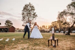 Gledswood Wedding - bride and groom play lawn games as sun sets behind them