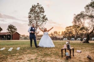 Gledswood Wedding - bride and groom play lawn games as sun sets behind them
