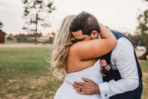 Gledswood Wedding - bride and groom hug as sun sets behind them