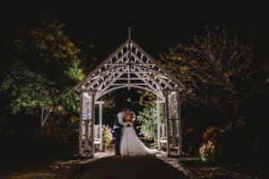 Gledswood Wedding - bride and groom at night in the venue gardens