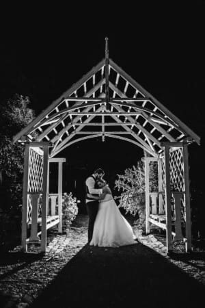 Gledswood Wedding - bride and groom at night in the venue gardens