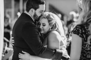 Gledswood Wedding - bride and groom cuddle during the ceremony