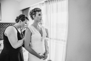 Sydney Wedding - Bridesmaids doing up the bridal gown