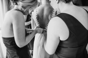 Sydney Wedding - bridesmaids zip up the bridal gown