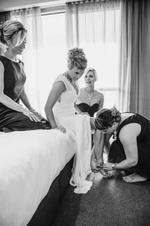 Sydney Wedding Photographer - Bridesmaids helping the bride with her shoes