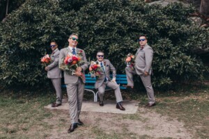 Sydney wedding photographer - Groomsmen strike a pose with the bridal bouquets
