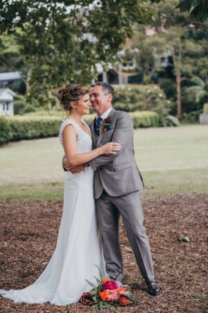 Sydney wedding photographer - A groom hugging his bride before the wedding