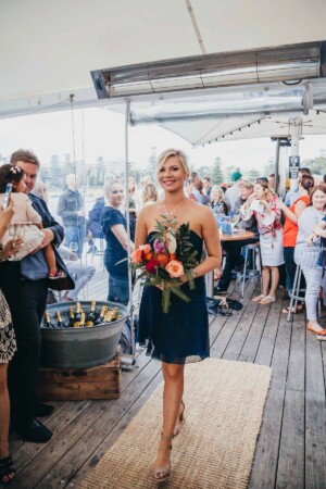 Sydney wedding photographer - Bridesmaid walking down the wedding aisle