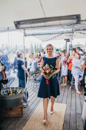 Sydney wedding photographer - bridesmaid walks down the aisle