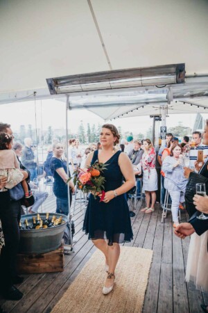 Sydney wedding photographer - bridesmaid walks down the aisle