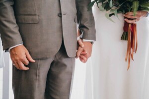 Sydney wedding photographer - Bride & groom hold hands during the wedding ceremony