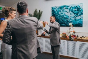 Sydney Wedding Photographer - groom and groomsman share a toast