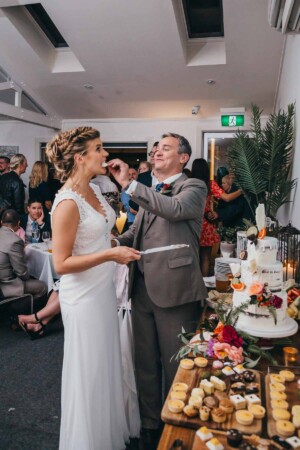 Sydney Wedding Photographer - groom feeds the bride some wedding cake