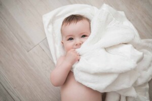 Baby boy chewing on his favourite blankie