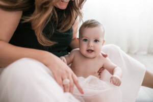 Little boy sitting in his mum's lap