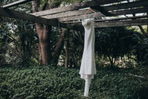 Chapel Hill Wedding - bridal gowns hanging from a pergola