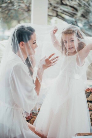 Chapel Hill Wedding - Flower girl and the bride playing under the veil