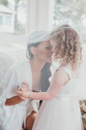 Chapel Hill Wedding - bride plays with the flower girl under the veil