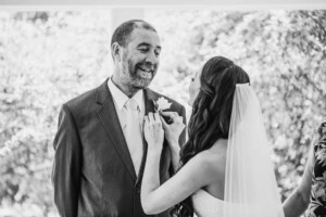 Chapel Hill Wedding - bride attaches her dad's buttonhole flower