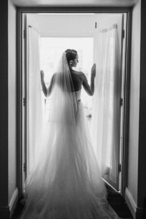 Chapel Hill Wedding - Bride standing in a doorway showing the dress back