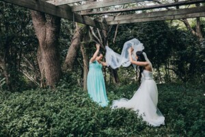 Chapel Hill Wedding - Bride and bridesmaid playing games under the veil