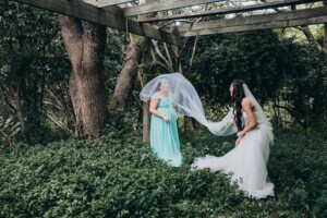 Chapel Hill Wedding - Bride and bridesmaid playing games under the veil