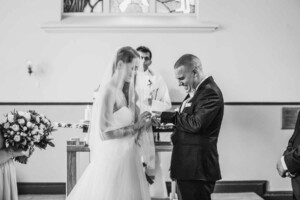 The bride and groom exchanging wedding rings