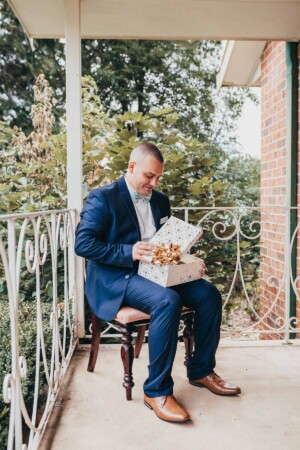 Groom opening his wedding gift from the bride