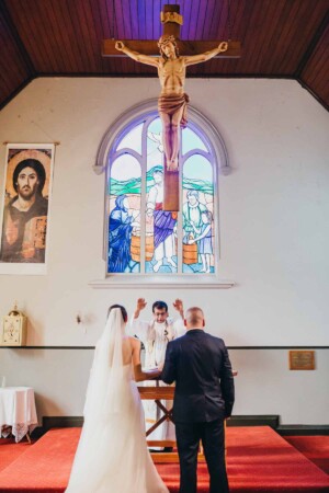 The priest blessing the bride and groom
