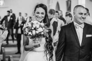 The bride and groom exit the church after the wedding