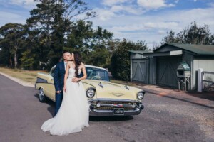 Bride & Groom share a kiss on their 57 chevy