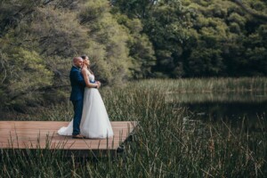 Newlyweds on the deck of Chapel Hill lakeside cabin