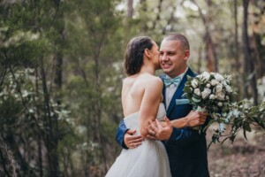 A bride whispers to her groom at Chapel Hill Retreat