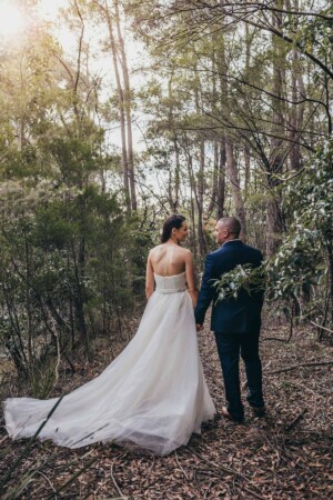 Newlyweds walking through the Chapel Hill bushland