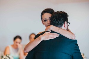 An emotional bride dances with her brother