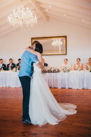 A bride dances with her brother at the reception