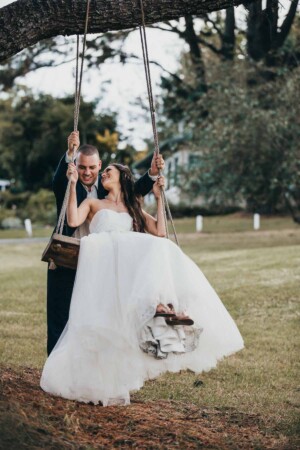 Newlyweds enjoy the swing at Chapel Hill Retreat