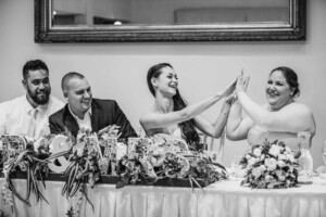 The bride high fives her sister at the reception