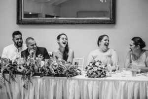 The bride laughs at her parents wedding speech