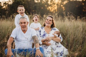 A family giggling at their toddlers antics