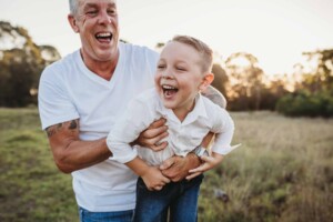 A dad lifting his little boy up like an aeroplane